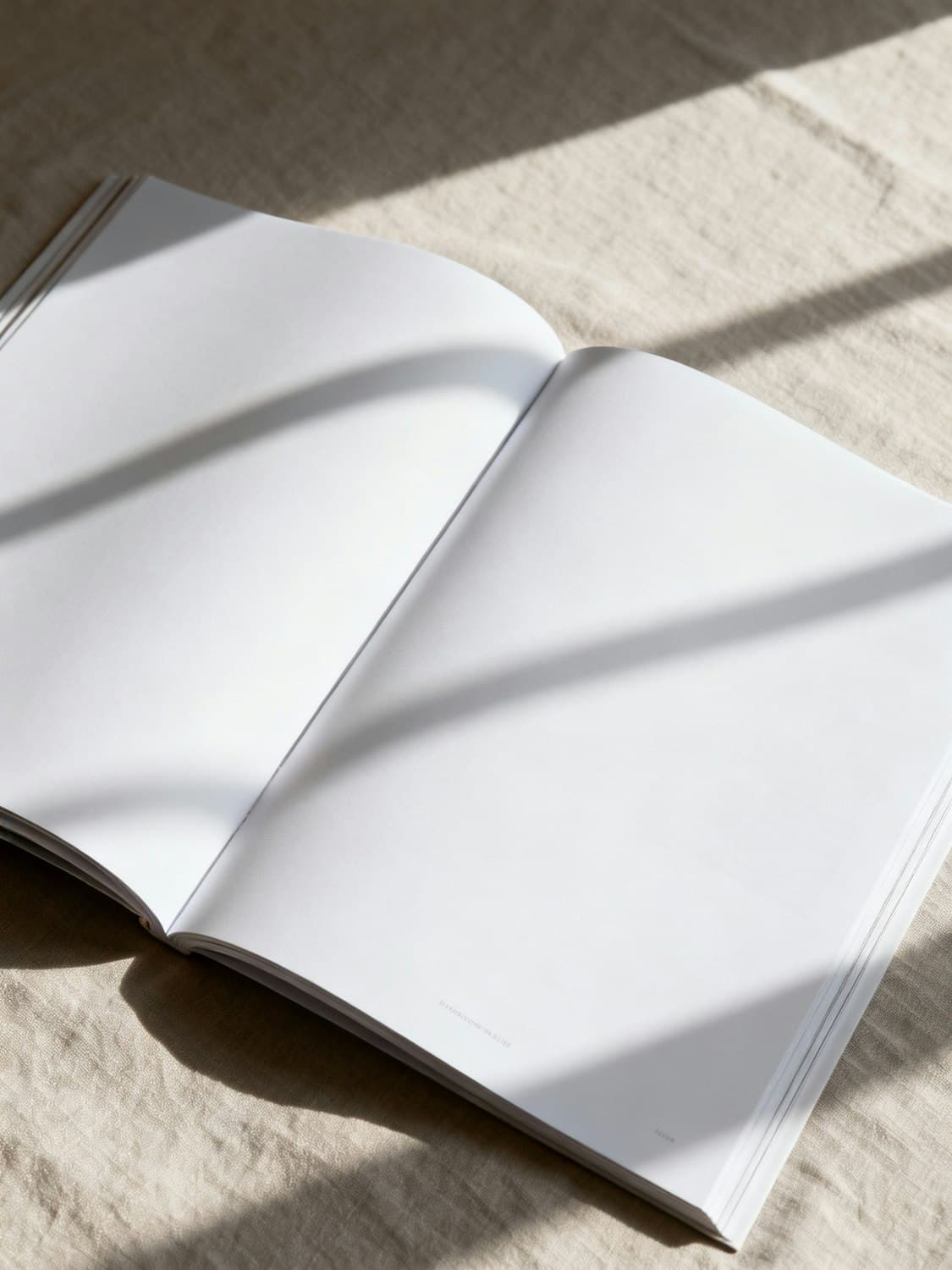 Open Maison Tevre brand book on beige fabric